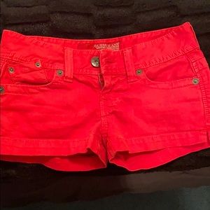 Red Guess shorts.
